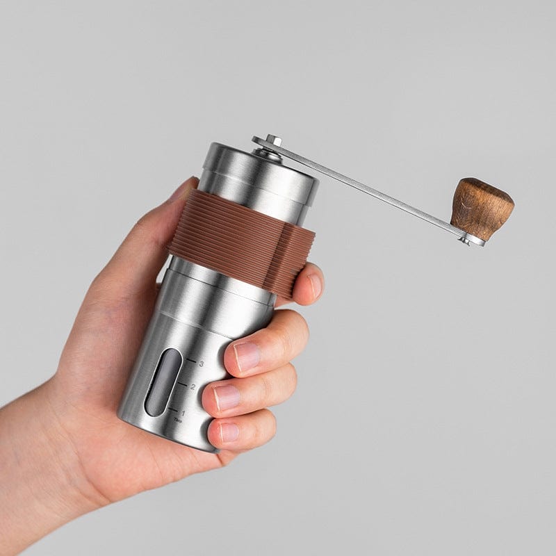Manual coffee grinder with adjustable settings and foldable handle