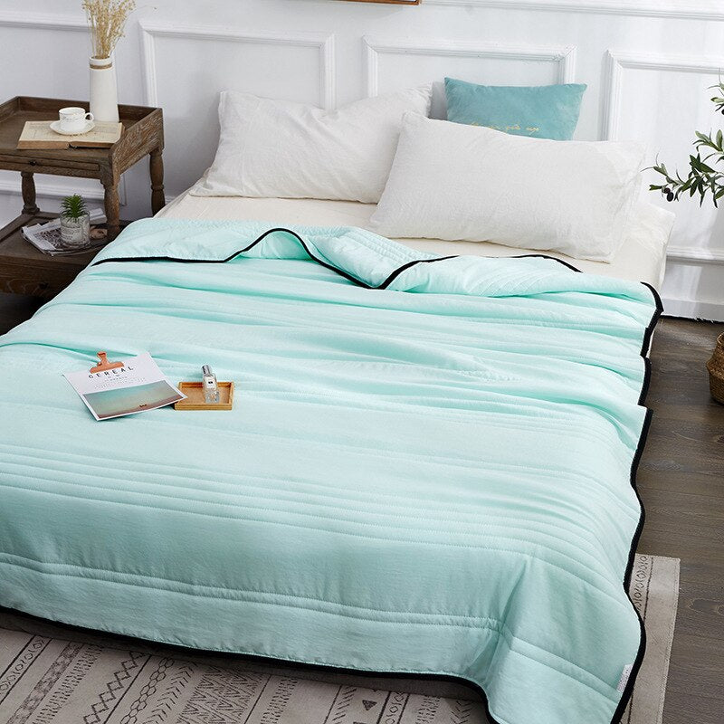 Cooling summer blanket with airy fabric construction - green