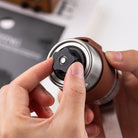 Manual coffee grinder with adjustable settings and foldable handle
