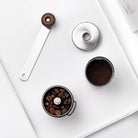 Manual coffee grinder with adjustable settings and foldable handle