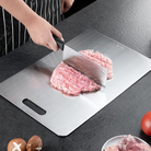 Cutting board with double sided titanium surface